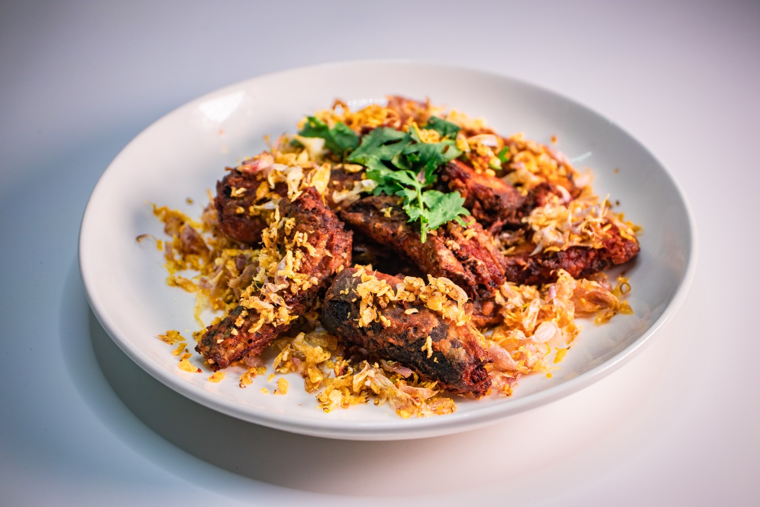 Fried canned fish with garlic.